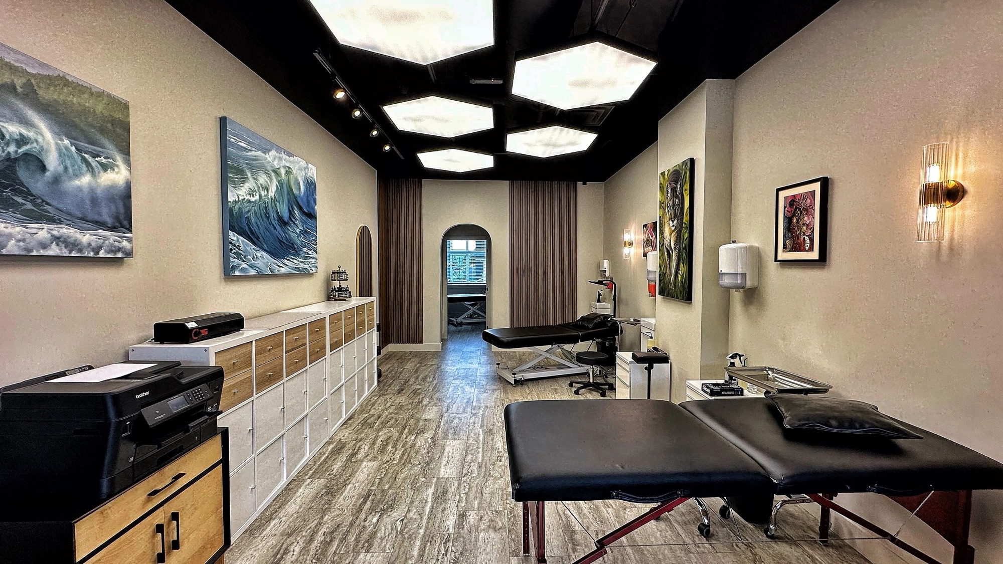 Ember Studio tattoo space in Kelowna, BC with fine-art ocean paintings